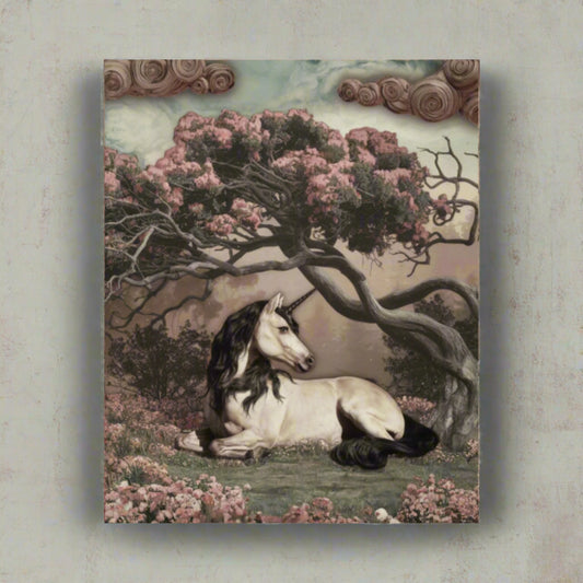 Unicorn lying under a flowering tree in a fantasy landscape